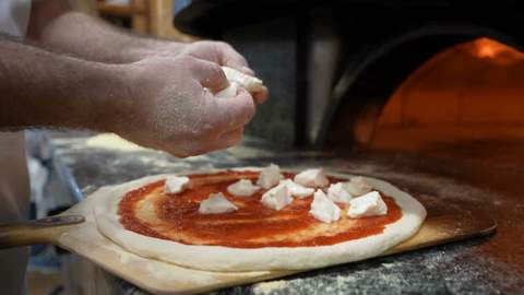Wood-fired oven, pizzaiolo at work, made with Iris Generate